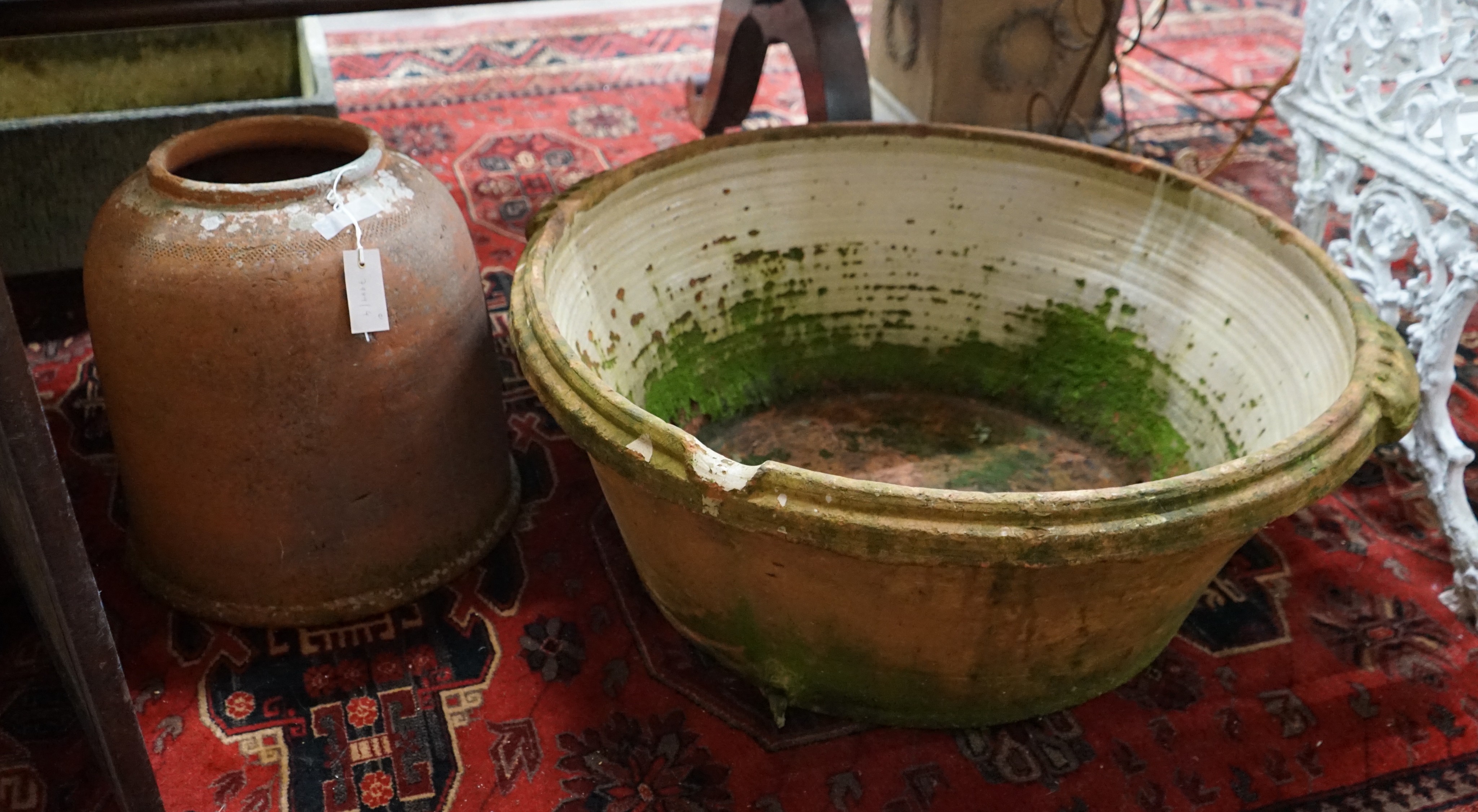 A large circular terracotta pail and a rhubarb planter, larger width 84cm, height 30cm